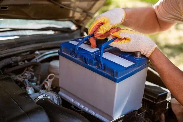 A car battery being changed by a mechanic.